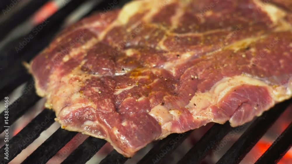 Cooking, juicy steak fried on an open fire on the grill