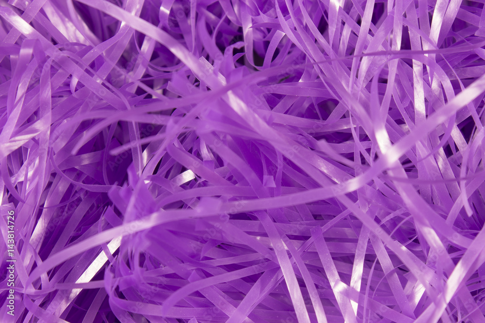 This is a photograph of Purple shredded plastic fake Easter grass background This is a photograph of Purple shredded plastic fake Easter grass background