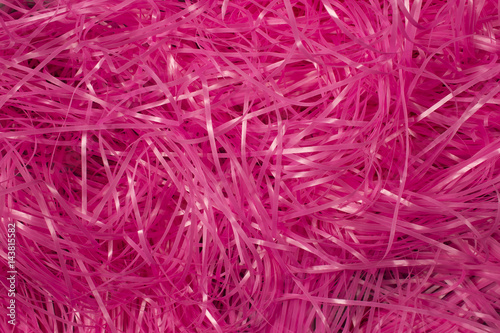 This is a photograph of Pink shredded plastic fake Easter grass background