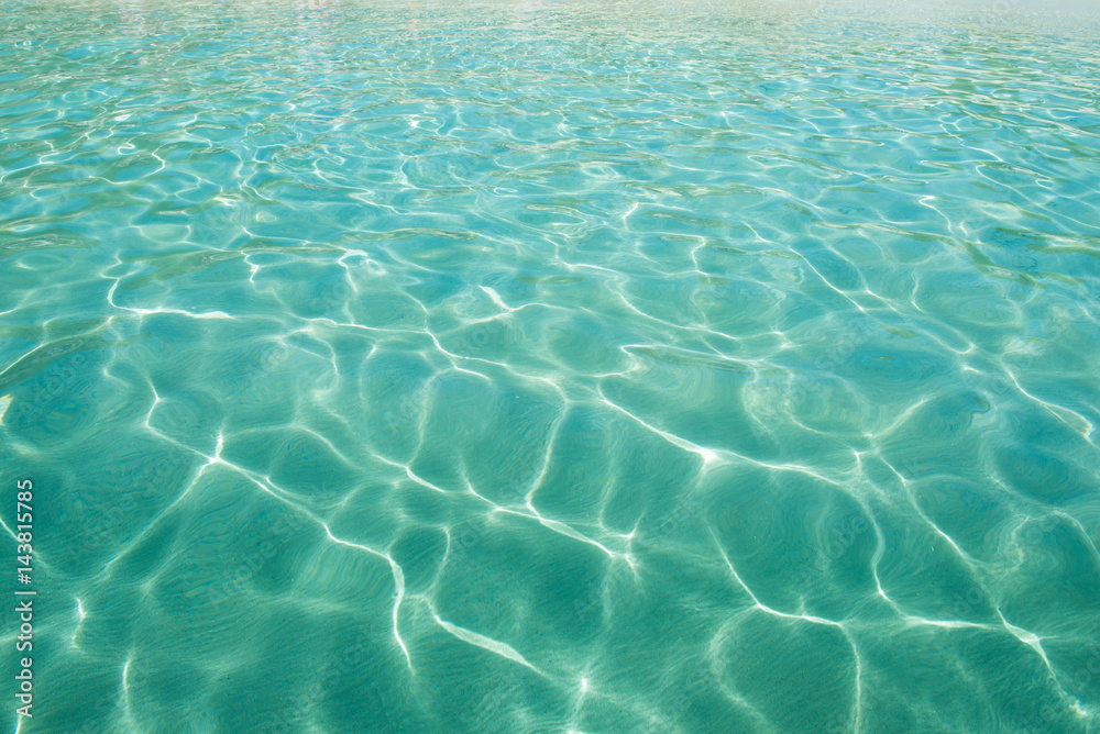 Shining blue water ripple background. Clear sea water background.