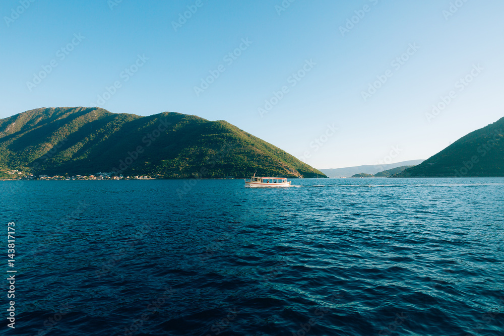 Boat in the Bay of Kotor. Montenegro, the water of the Adriatic Sea. Boats, yachts, liners.