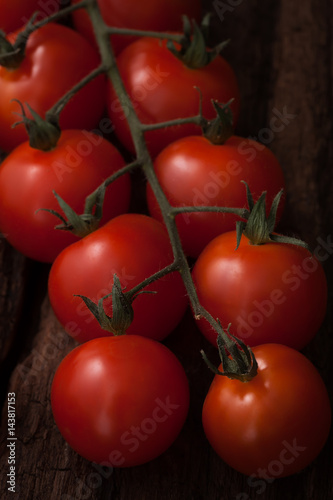  organic fresh cherry tomatoes on wooden background