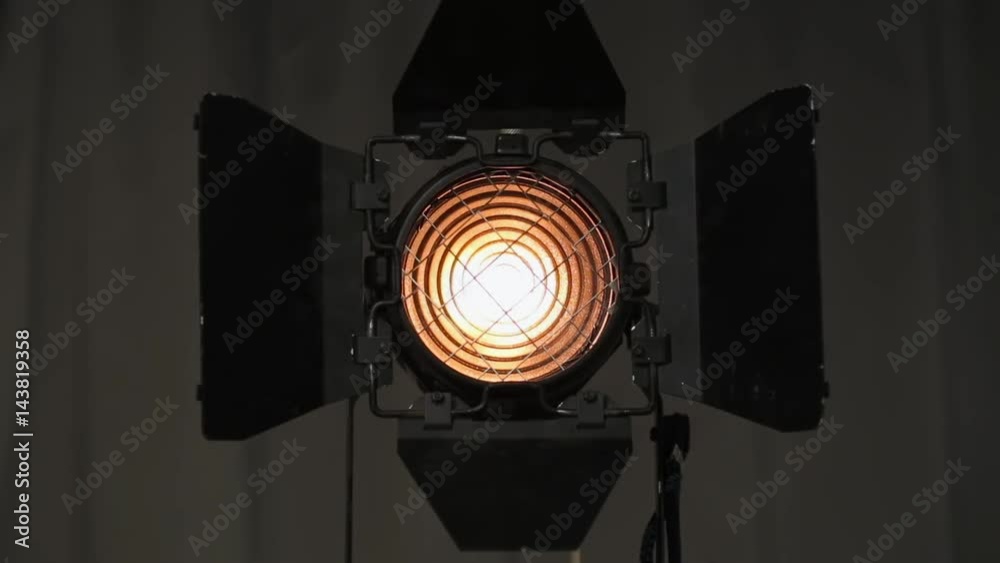 Footage of studio light being turned on and off. Floodlight flashes