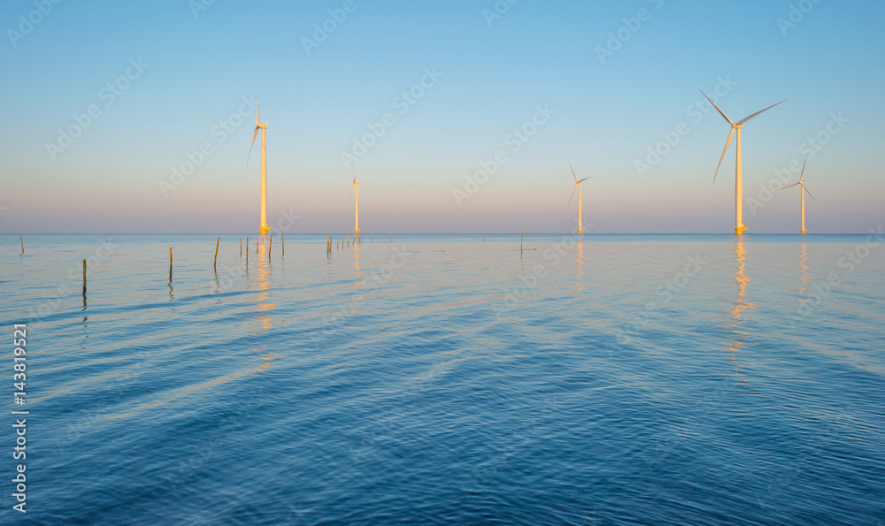 Wind turbines in a lake at sunrise