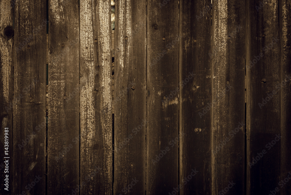 Obraz premium Old rural wooden wall in dark brown and black colors, detailed plank photo texture. Natural wooden building structure background.