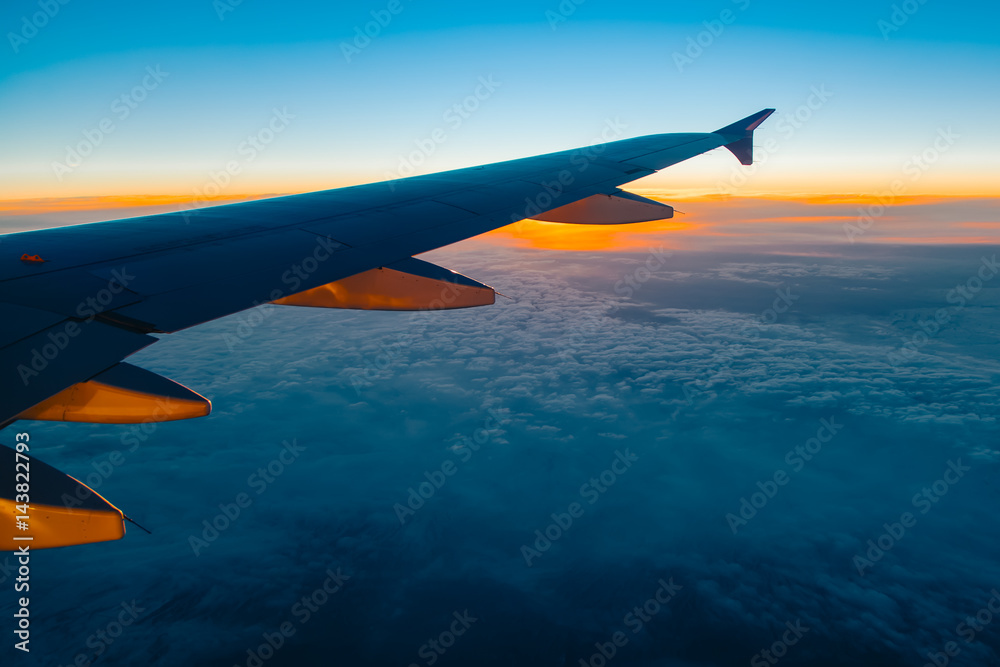 Fototapeta premium Aerial view from airplane window at sunset