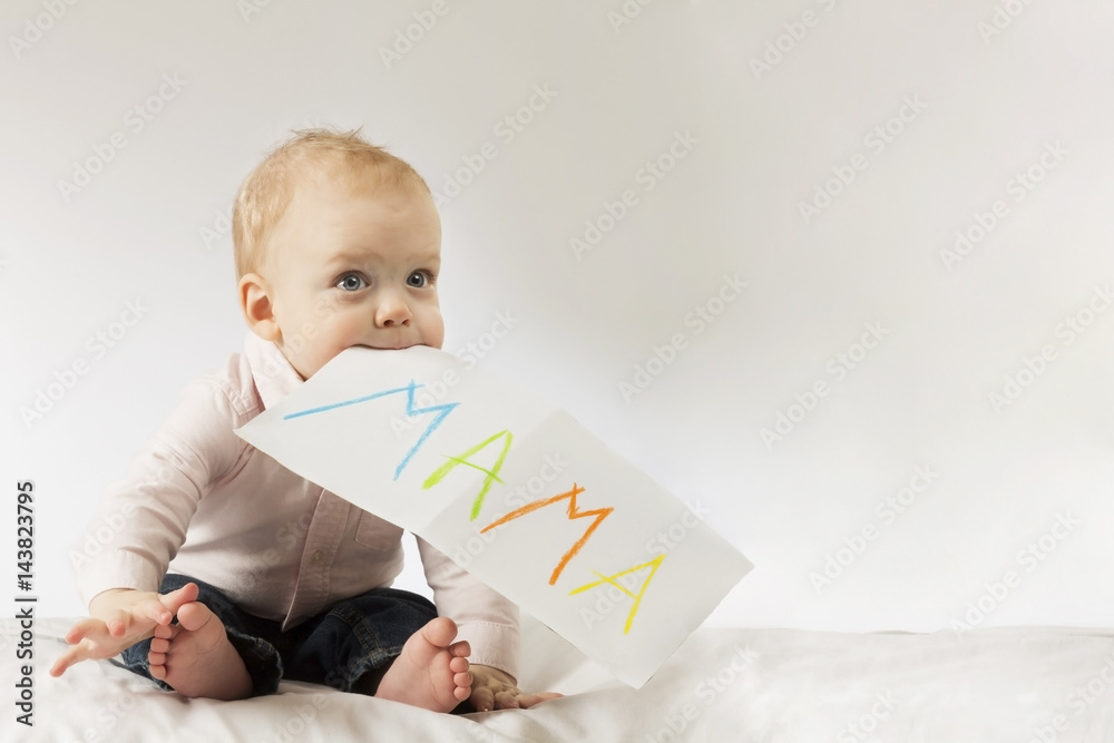 Funny little boy with poster in his mouth. Idea for Mothers day postcard. Copy space Funny little boy with poster in his mouth. Idea for Mothers day postcard. Copy space