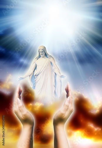 Jesus Christ in two hands over divine sky with rays of Light like y asymbol of Christianity, love, peace, blessing  photo