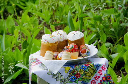 
Easter still life stands on the background of a flower bed. photo