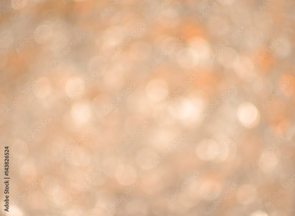 Bokeh background blur of duo tone sparkles in warm tones