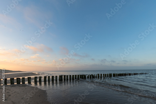 Fototapeta Naklejka Na Ścianę i Meble -  Timber Piles At Renesse Beach Zeeland / Netherland