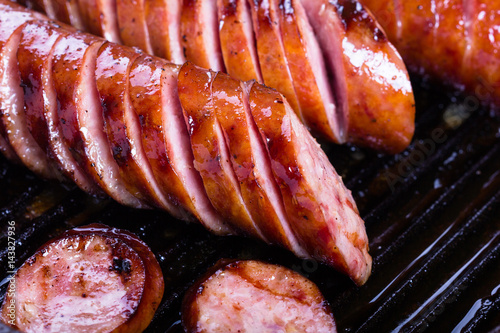 Fried pork sausages on a cast iron skillet.