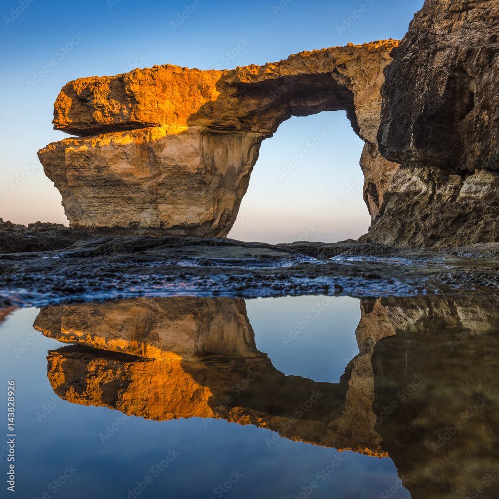 Gozo, Malta - Sunriseat the beautiful Azure Window, a natural arch and famous landmark on the island of Gozo with reflection. It's been collapsed on 9th of March, 2017