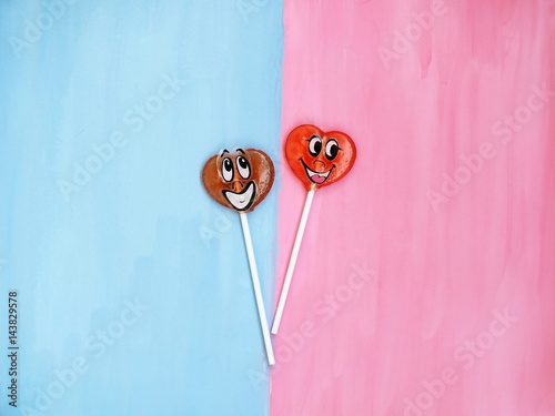 Two lollipops on pink and blue background. Love concept. Valentines day