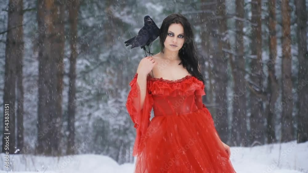 Beautiful girl with a raven on his shoulder looks up sharply Beautiful girl with a raven on his shoulder looks up sharply