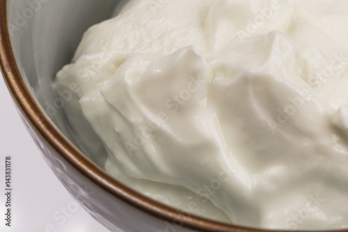 Bowl of greek yogurt isolated on white background