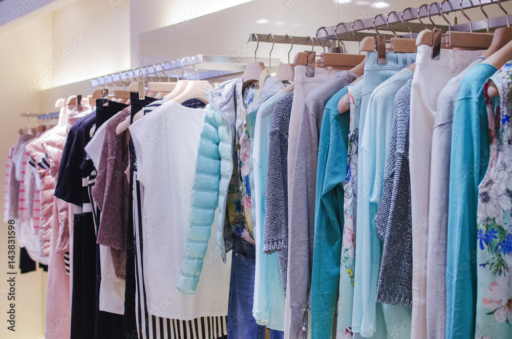 Women clothes on racks in a fancy store. Women clothes on racks in a fancy store.