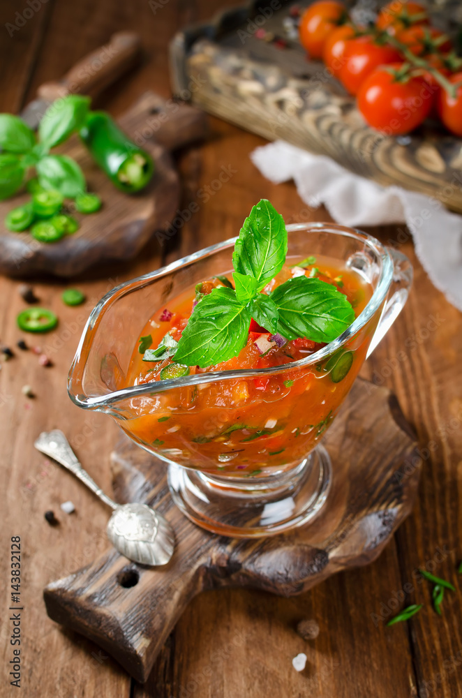 Sauce from tomato, paprika, chili pepper and a branch of basil Sauce from tomato, paprika, chili pepper and a branch of basil