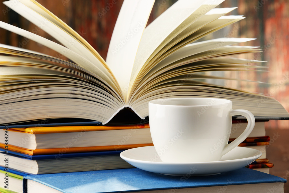 Naklejka premium Composition with books and cup of coffee