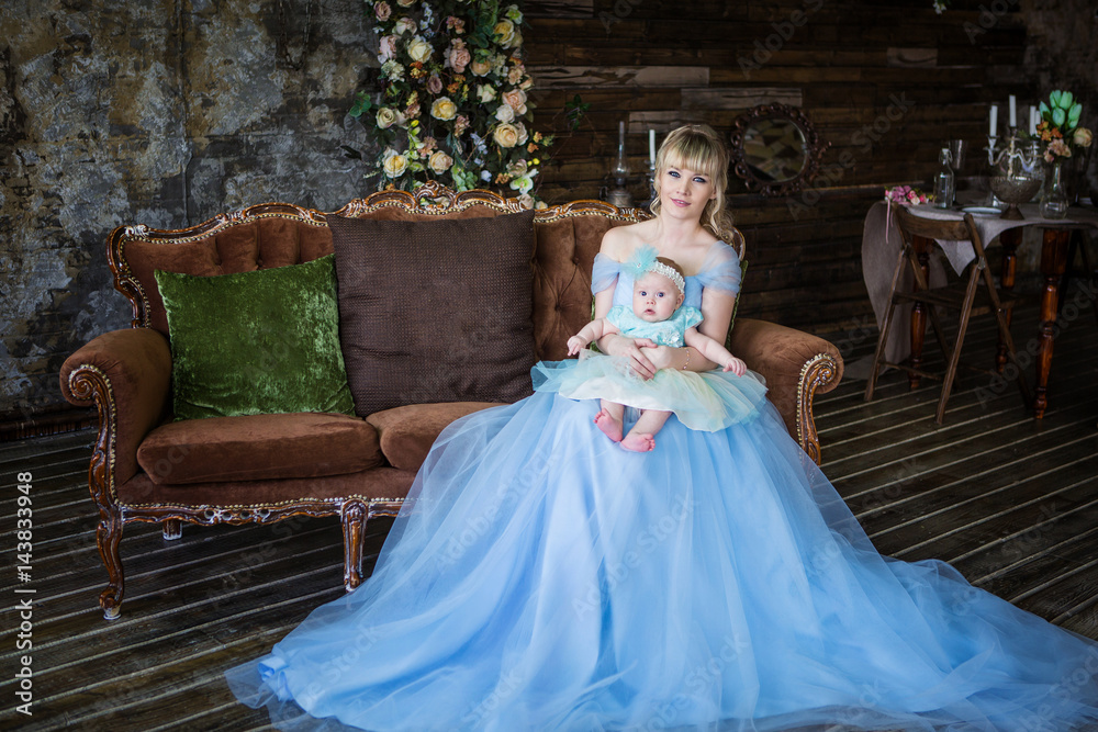 Fototapeta premium Mom and little daughter in beautiful dresses