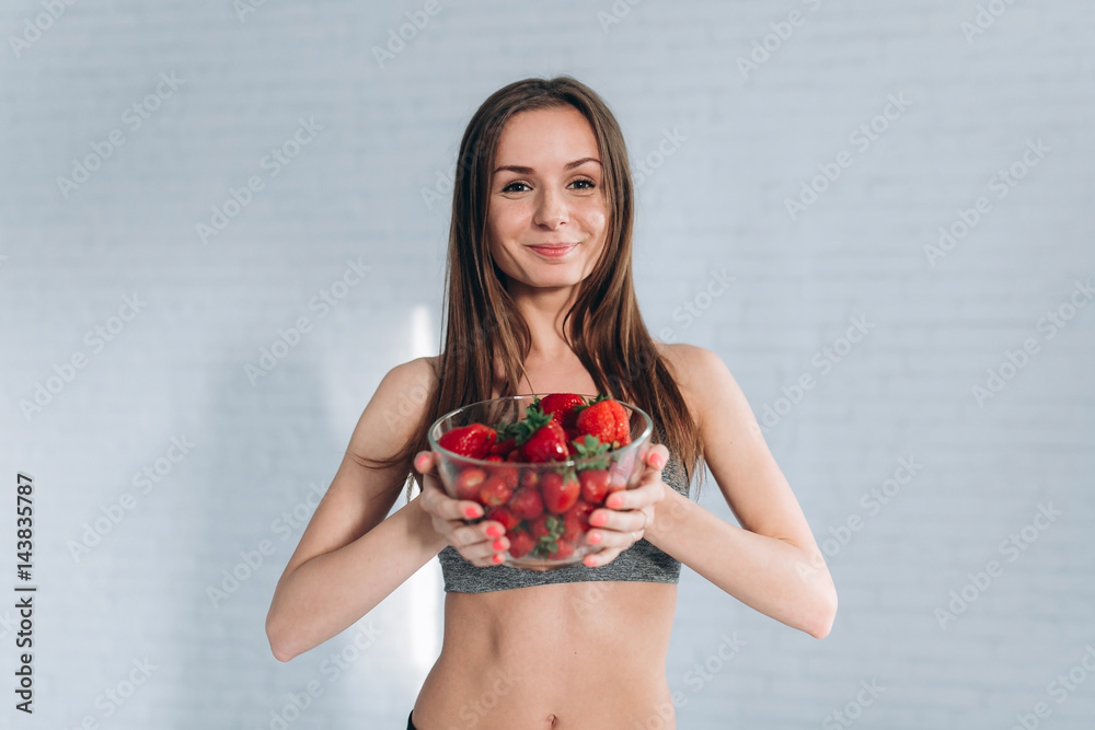 Girl holding plate of strawberries. Girl holding plate of strawberries.