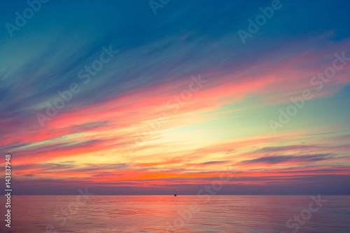 Fiery orange sunset sky warm light with clouds, Beautiful for background with offshor oil and gas platform background