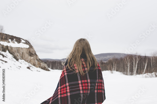 Travel girl with plaid outdoors in the winter day.