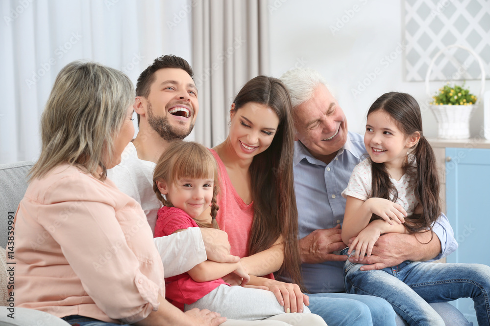 Happy family sitting on sofa in the room