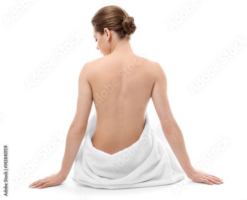 Beautiful naked woman with towel on white background