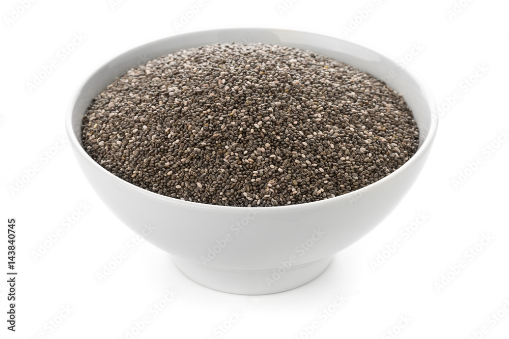 Raw, unprocessed, dried black chia seeds in white bowl on white Raw, unprocessed, dried black chia seeds in white bowl on white