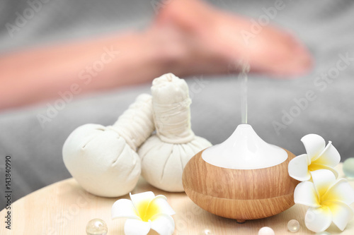 Spa concept. Aroma oil diffuser on table against blurred background