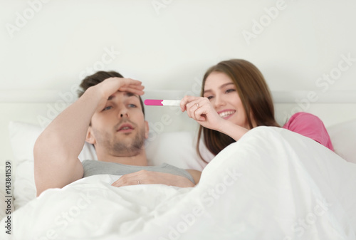 Happy young woman showing p...