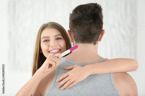 Smiling young woman hugging...
