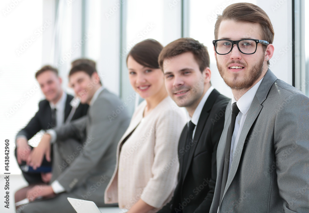 Smiling and confident business team having time break in front o Smiling and confident business team having time break in front o