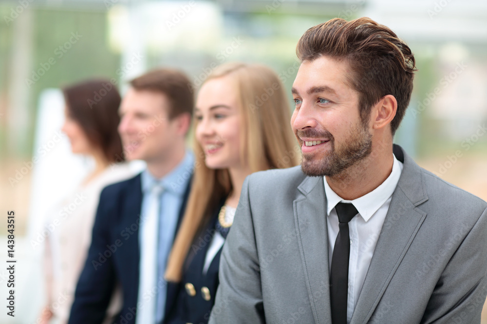 Business people standing in a row looking in same direction Business people standing in a row looking in same direction