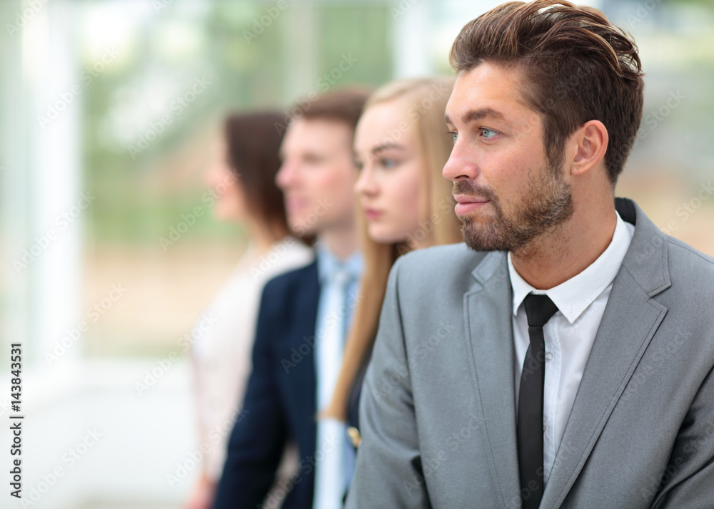 Business people standing in a row looking in same direction Business people standing in a row looking in same direction