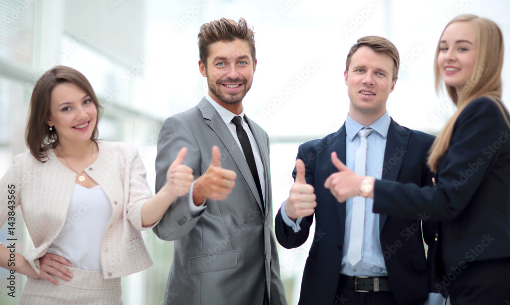 Elegant co-workers looking at camera during meeting in office Elegant co-workers looking at camera during meeting in office