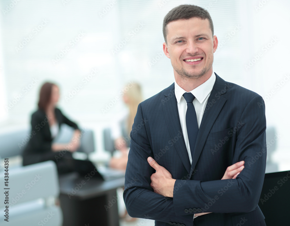 Portrait of a smiling business man with colleagues working in th Portrait of a smiling business man with colleagues working in th
