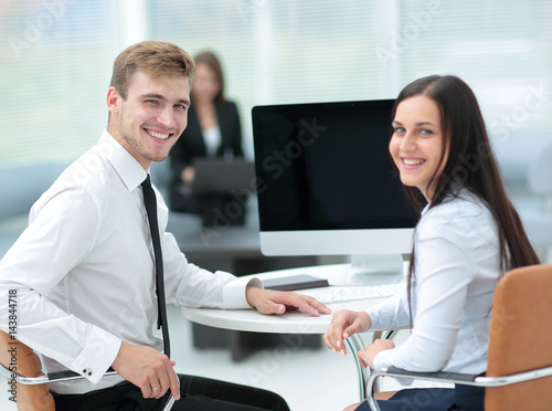 Image of two young business people interacting at meeting in off