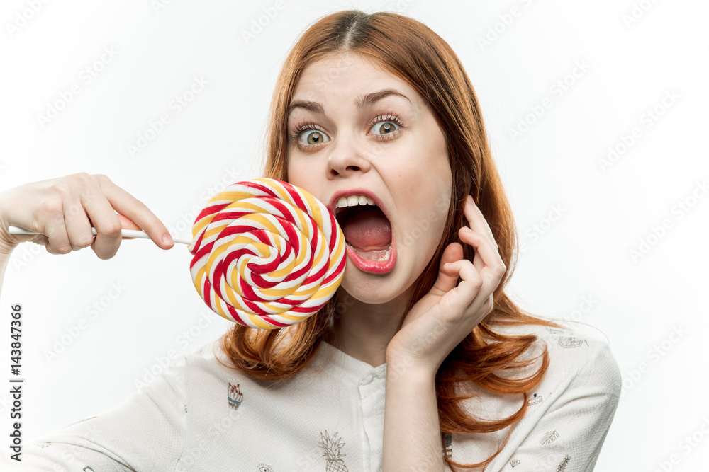 emotional woman with wide mouth open, round lollipop