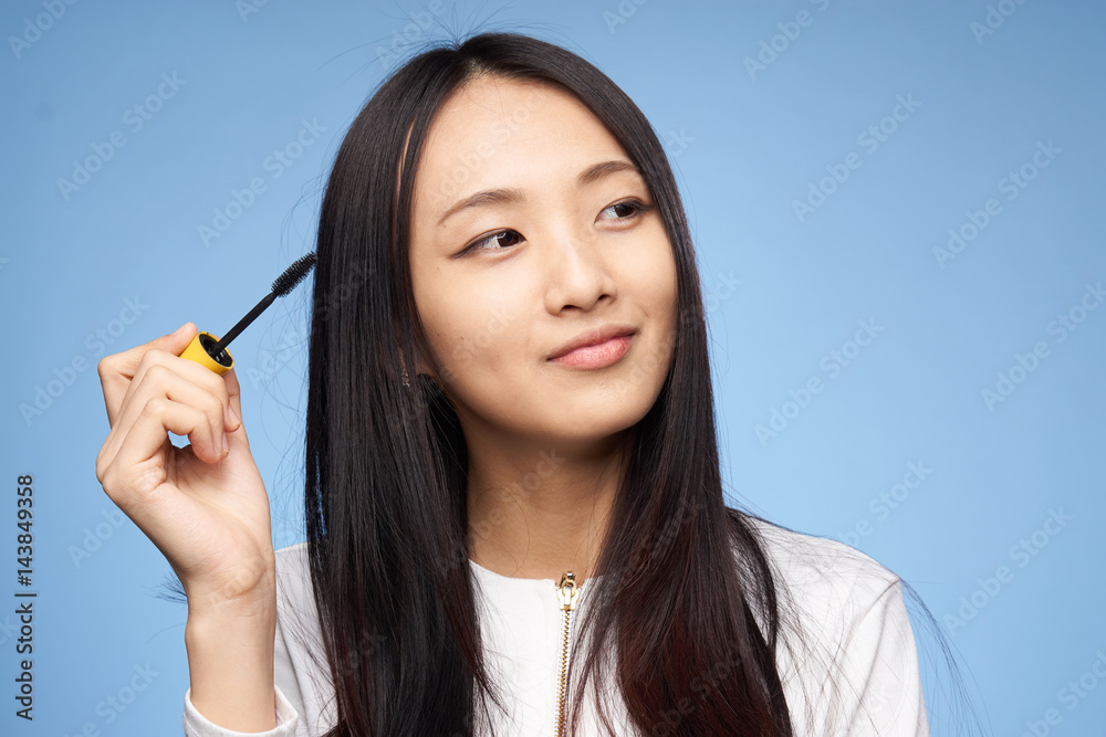 brush for dyeing eyelashes in the hand of an attractive woman brush for dyeing eyelashes in the hand of an attractive woman