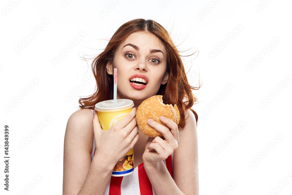 fast food and a glass of drink in the hands of emotional women fast food and a glass of drink in the hands of emotional women