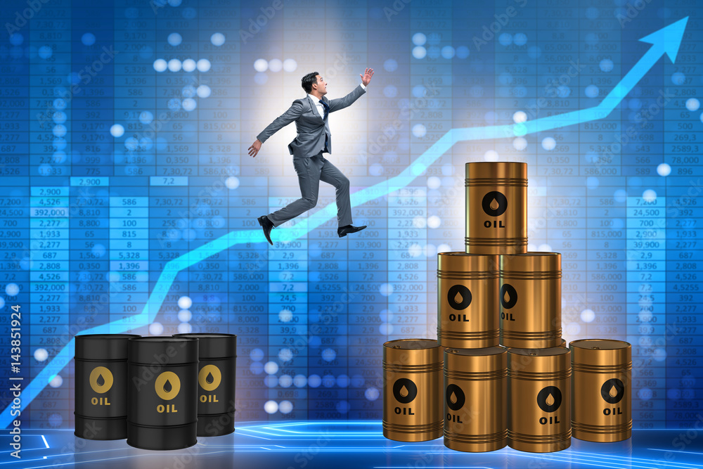 Businessman jumping from stack of oil barrels