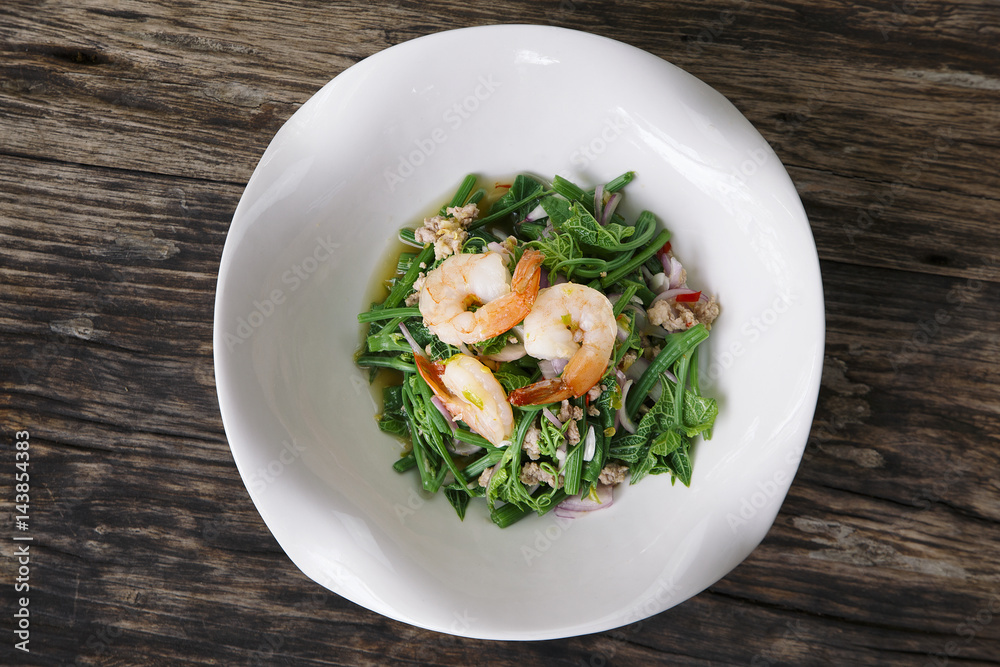 Bitter gourd Stem Spicy thai Salad with Shrimp on wooden background Bitter gourd Stem Spicy thai Salad with Shrimp on wooden background
