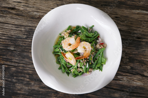 Bitter gourd Stem Spicy thai Salad with Shrimp on wooden background