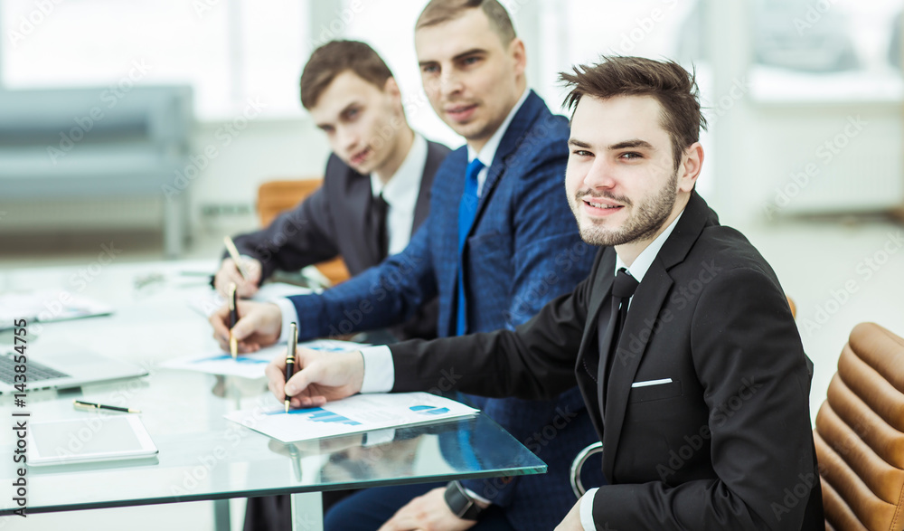 Manager Finance and business team are working with financial charts at his Desk Manager Finance and business team are working with financial charts at his Desk