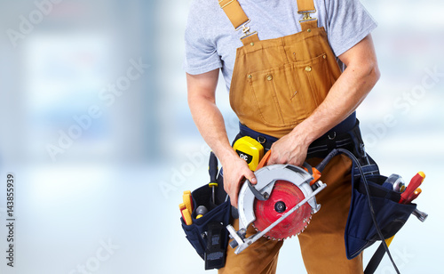 Construction worker with electric saw