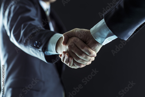 concept of partnership in business: a handshake of business partners. photo