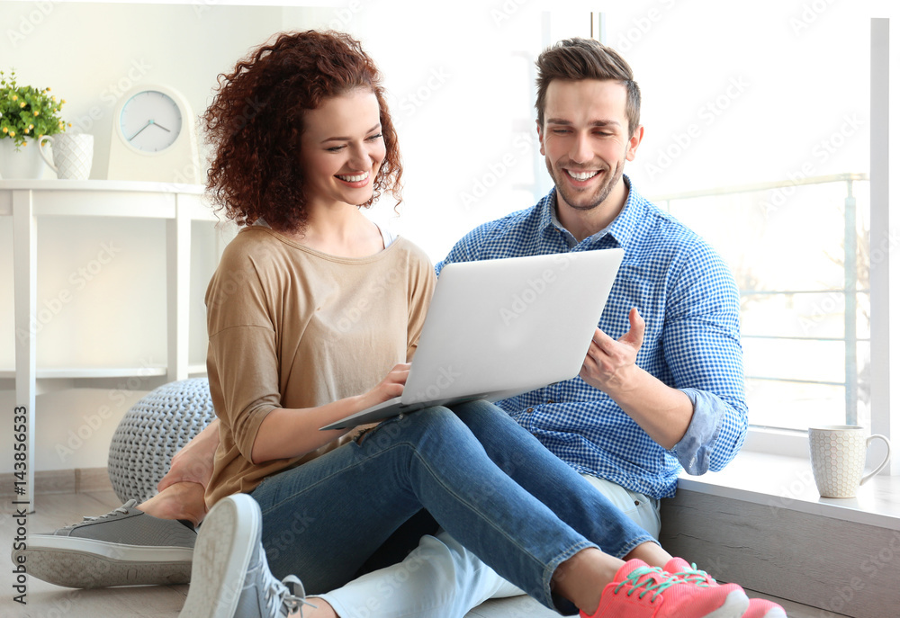 Happy young couple with laptop at home Happy young couple with laptop at home