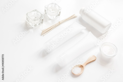 white set of cosmetics for spa on table background
